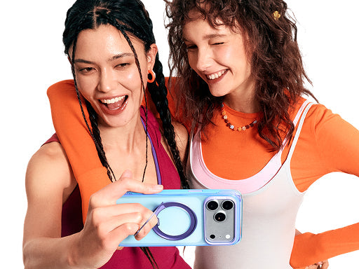 Two women posing with a smartphone in a colorful magnetic ring stand case