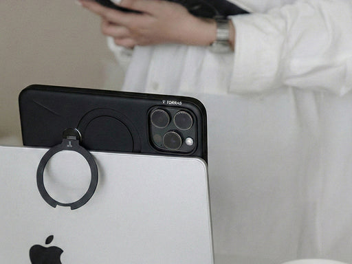 Magnetic phone with ring holder attached to a laptop, showing convenient storage and easy access