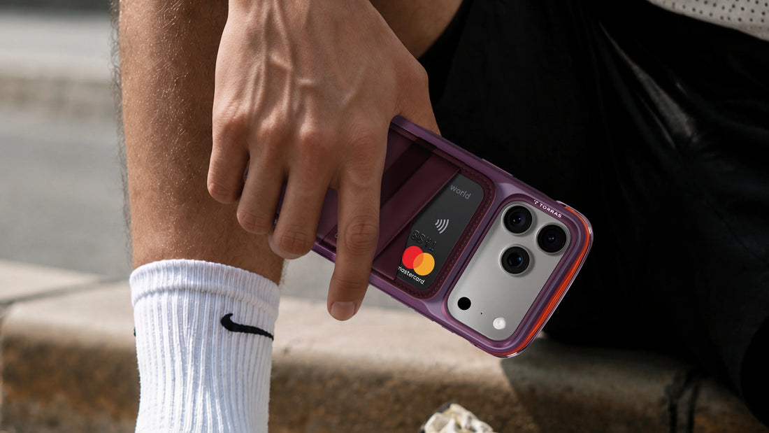 Hand holding an iPhone 18 Pro Max with a MagSafe wallet holding a credit card