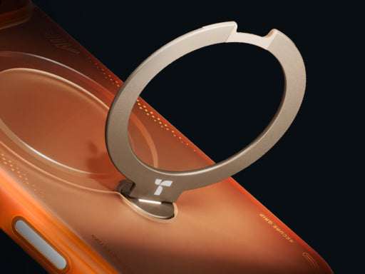 Close-up of an orange phone case with a raised metal ring stand for secure grip and hands-free viewing