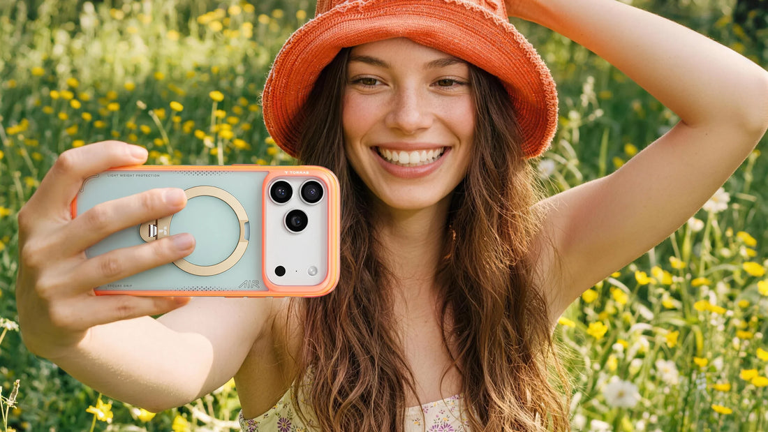 Smiling woman taking a selfie outdoors with a TORRAS phone case featuring a ring stand