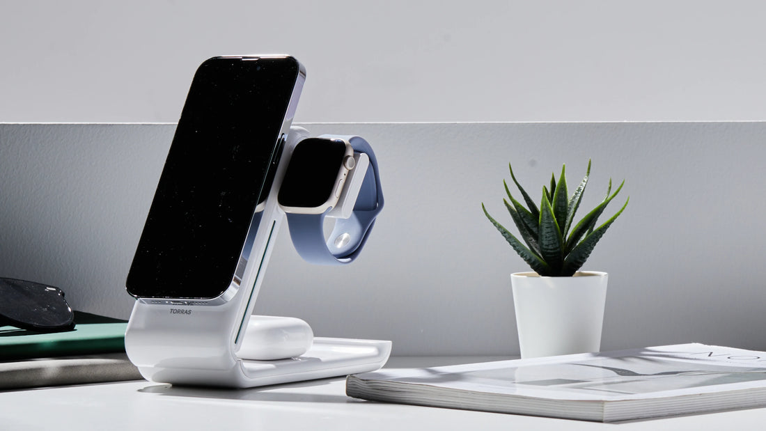 TORRAS charging stand holding a smartphone and smartwatch on a minimalist white desk