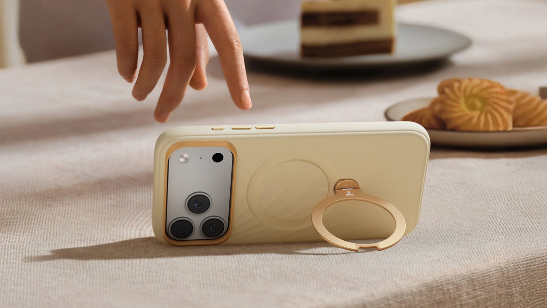 Cream TORRAS phone case with a metal ring stand supporting the phone in landscape mode