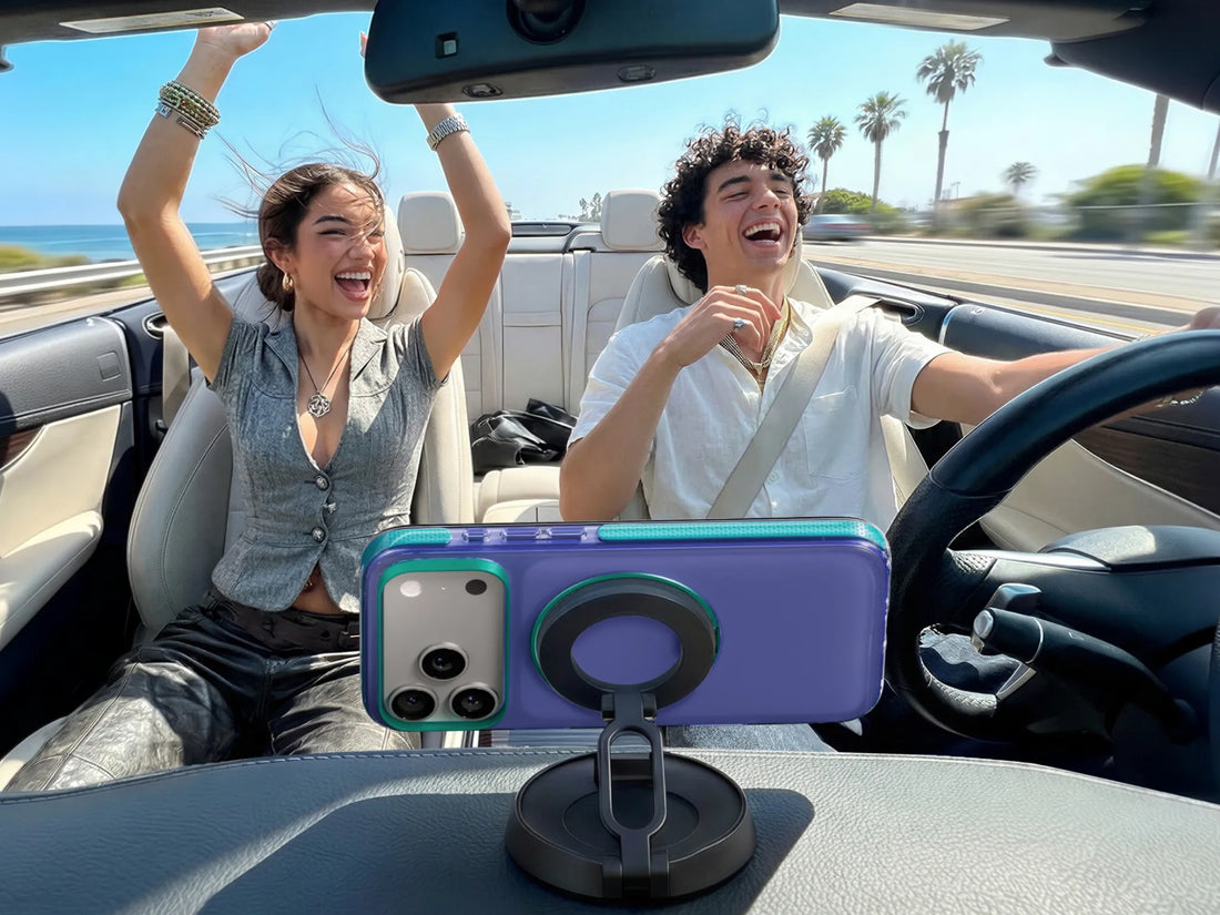 Airbag phone case mounted on a car dashboard during a sunny road trip with two passengers laughing