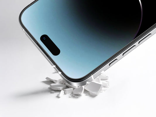 Close-up phone corner pressing into broken pieces to demonstrate impact protection