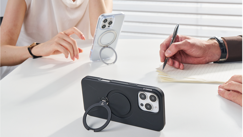 Ring stand phone cases propped on a meeting table during note-taking