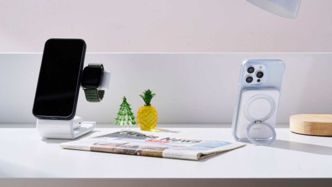MagSafe phone case with ring stand beside a wireless charger on a bright desk