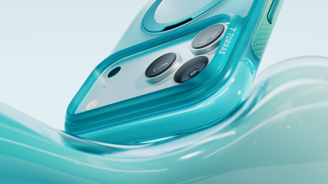 Close-up of a turquoise MagSafe phone case with reinforced camera protection and raised edges