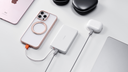 TORRAS portable charger powering iPhone and AirPods on a clean desktop setup