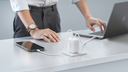TORRAS charger powering a phone and laptop on a clean office desk