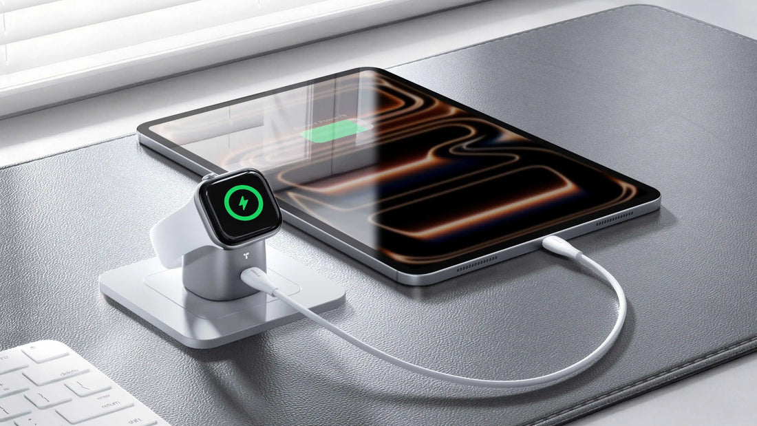 Apple Watch charging on a TORRAS stand beside a tablet connected by cable on a desk