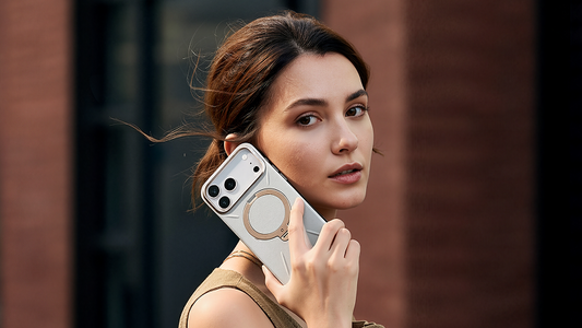 Woman holding a smartphone in a clear case with a circular metal stand