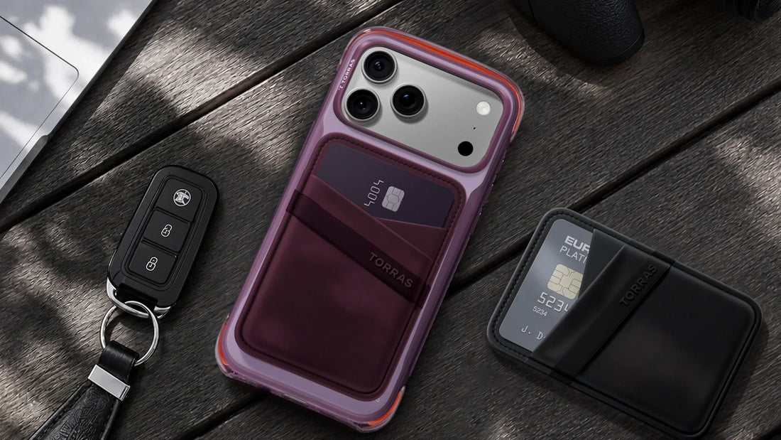 A dark desk with an iPhone 18 Pro in a purple stand case and an attached MagSafe wallet