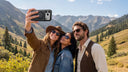 Group of four friends taking a selfie with a phone held at arm's length