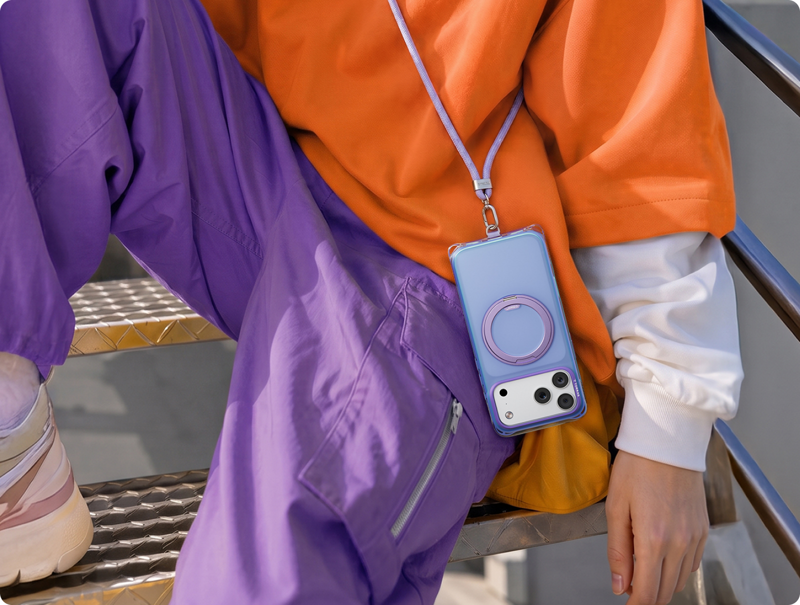Woman with a phone on a TORRAS crossbody lanyard