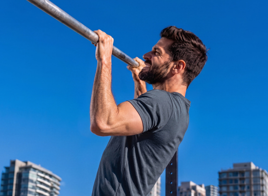 Man doing pull-ups on an outdoor bar