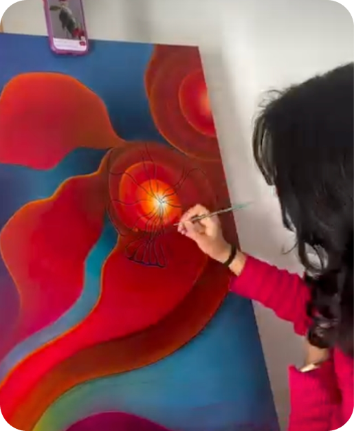 Artist painting with her phone mounted on the wall nearby