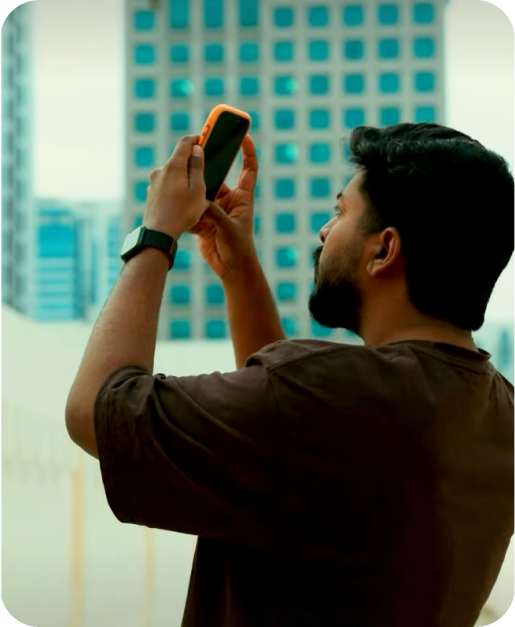 Man photographing architecture with a phone in a TORRAS case