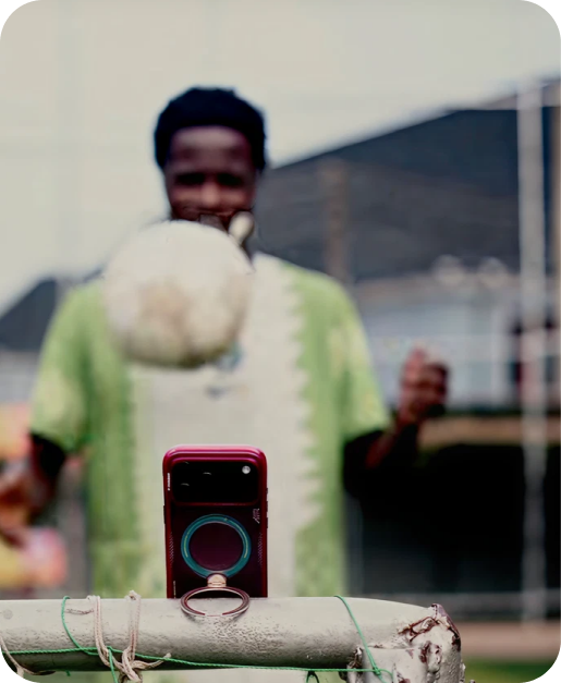 Phone filming a footballer from its TORRAS ring stand
