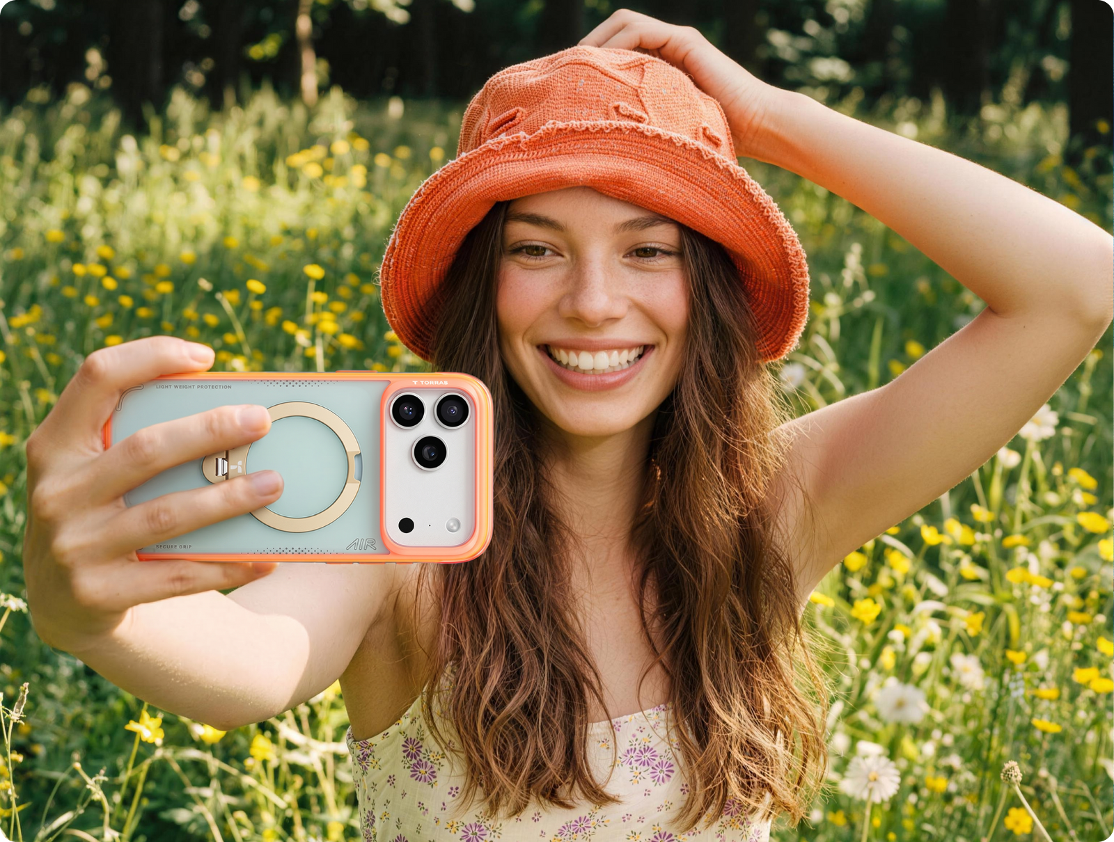 Woman in a meadow taking a selfie with a TORRAS ring case