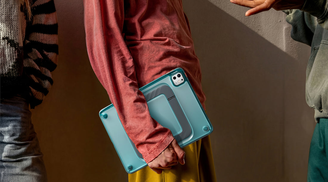 Carrying an iPad in a teal TORRAS case on the street