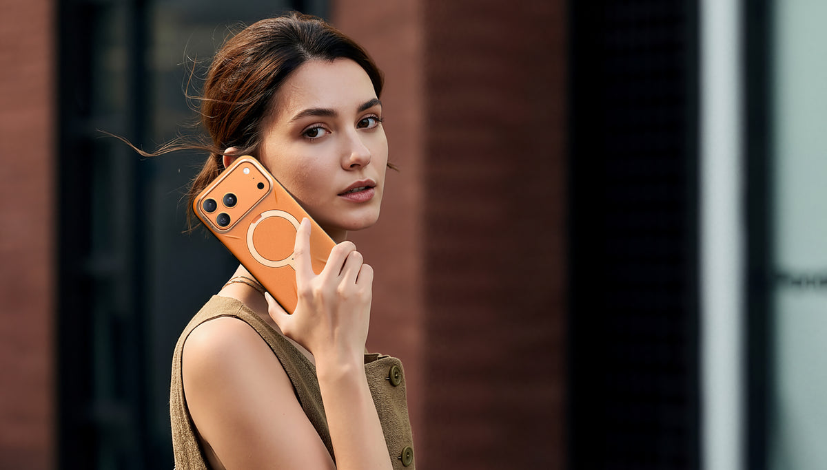 Woman on a call with a phone in an orange TORRAS case